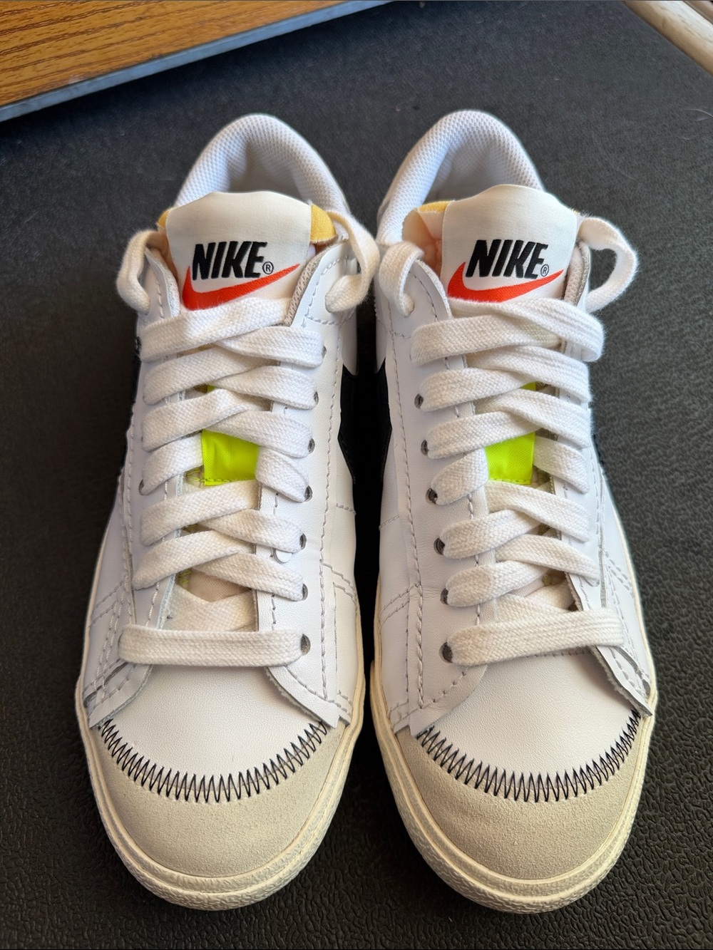 Nike White Sneakers with Neon Yellow Tongue Tab and Orange Swoosh